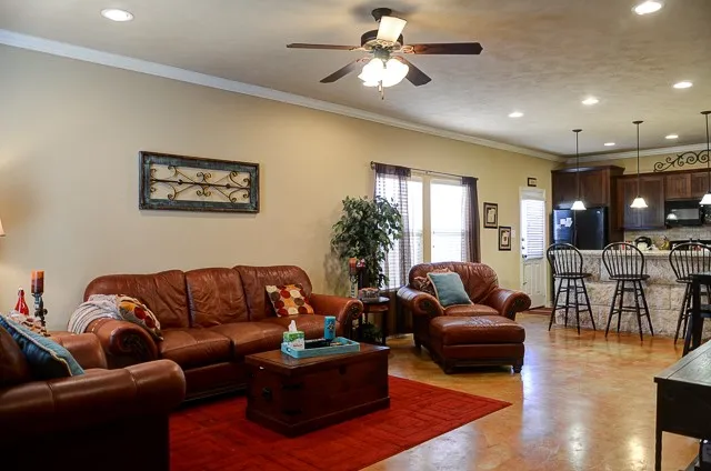 a living room with furniture ceiling fan and a rug