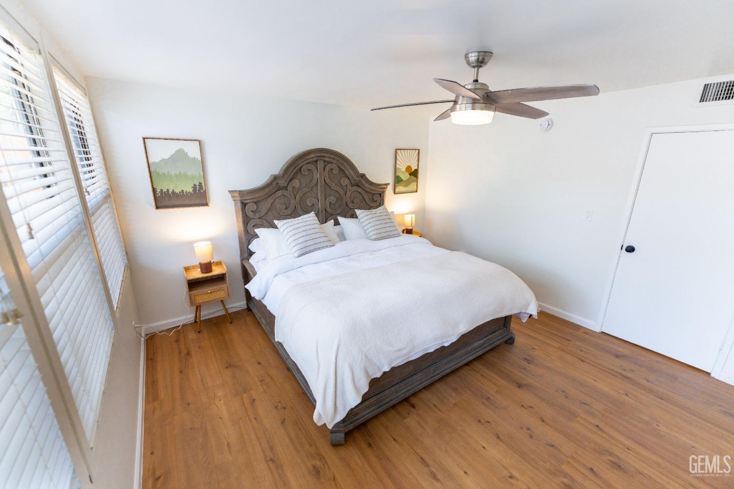 Undisclosed Address Bakersfield, CA 93306 - Photo 12 of 20 a bedroom with a bed and wooden floor