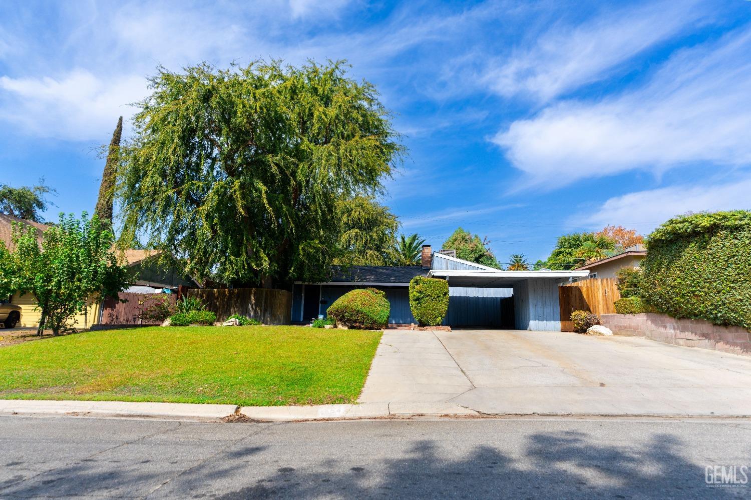 Undisclosed Address Bakersfield, CA 93306 - Photo 2 of 20 a view of a house with a yard and potted plants