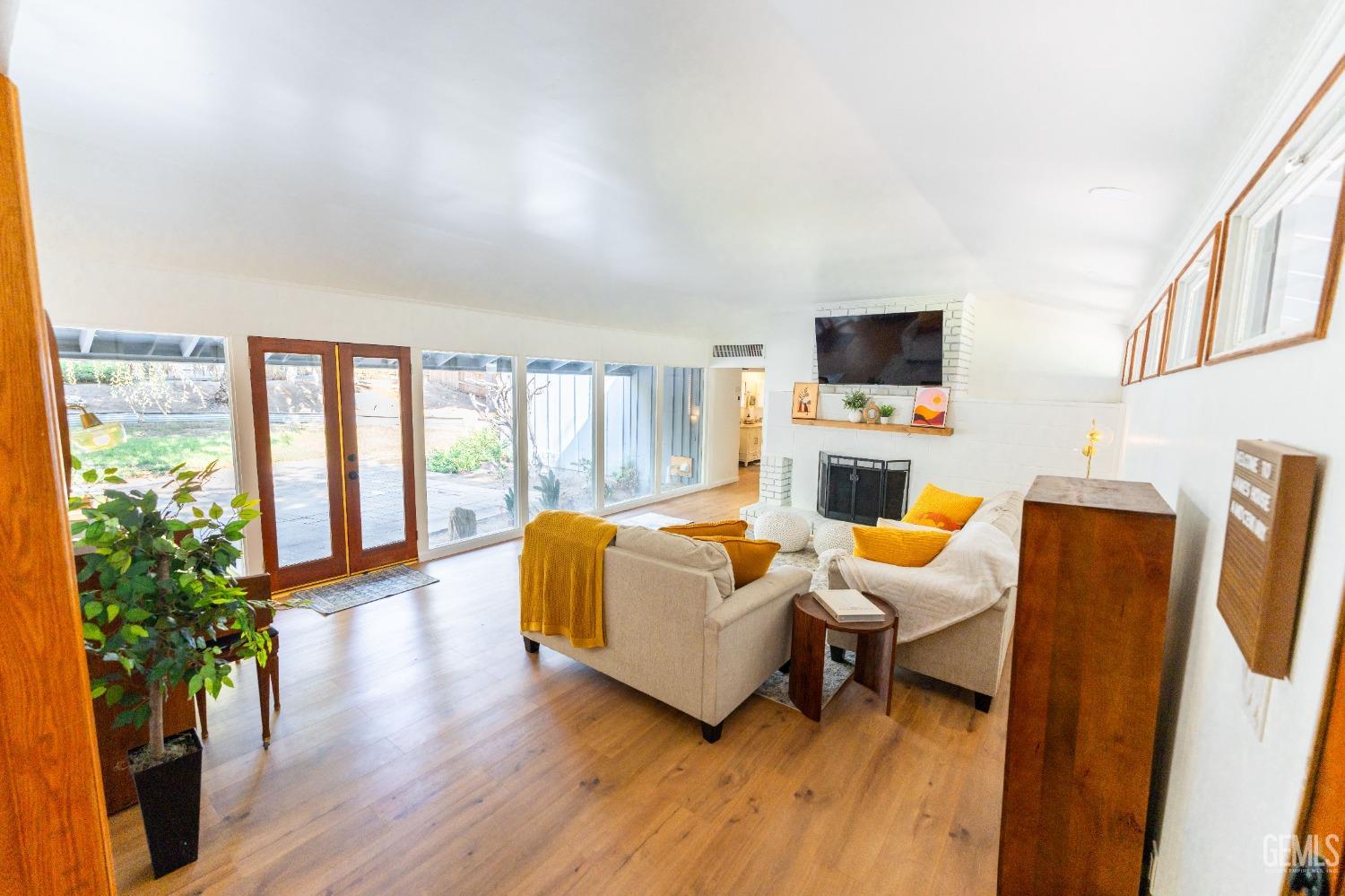 Undisclosed Address Bakersfield, CA 93306 - Photo 3 of 20 a living room with furniture a flat screen tv and a large window