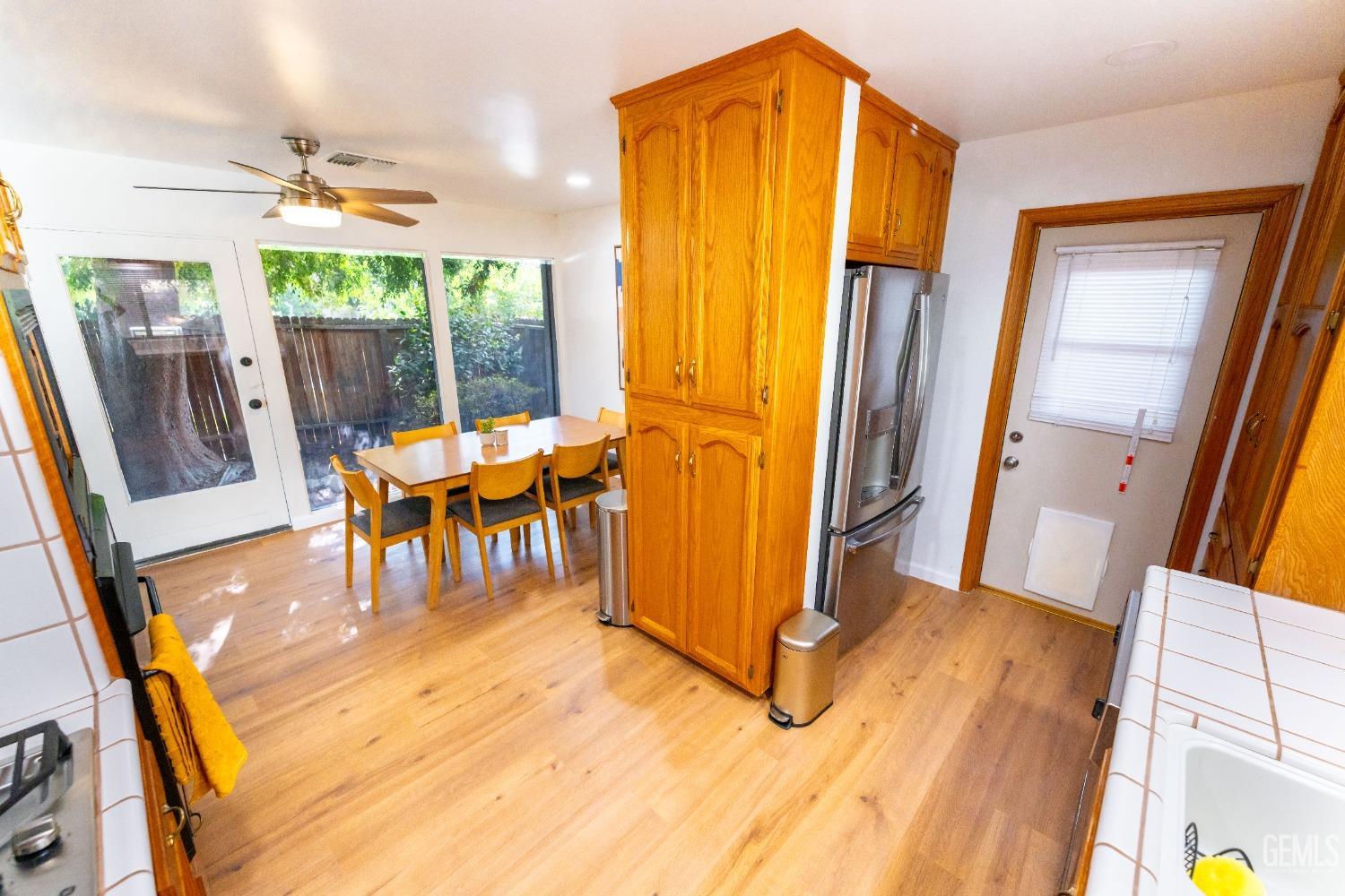 Undisclosed Address Bakersfield, CA 93306 - Photo 9 of 20 a dining room with furniture and wooden floor