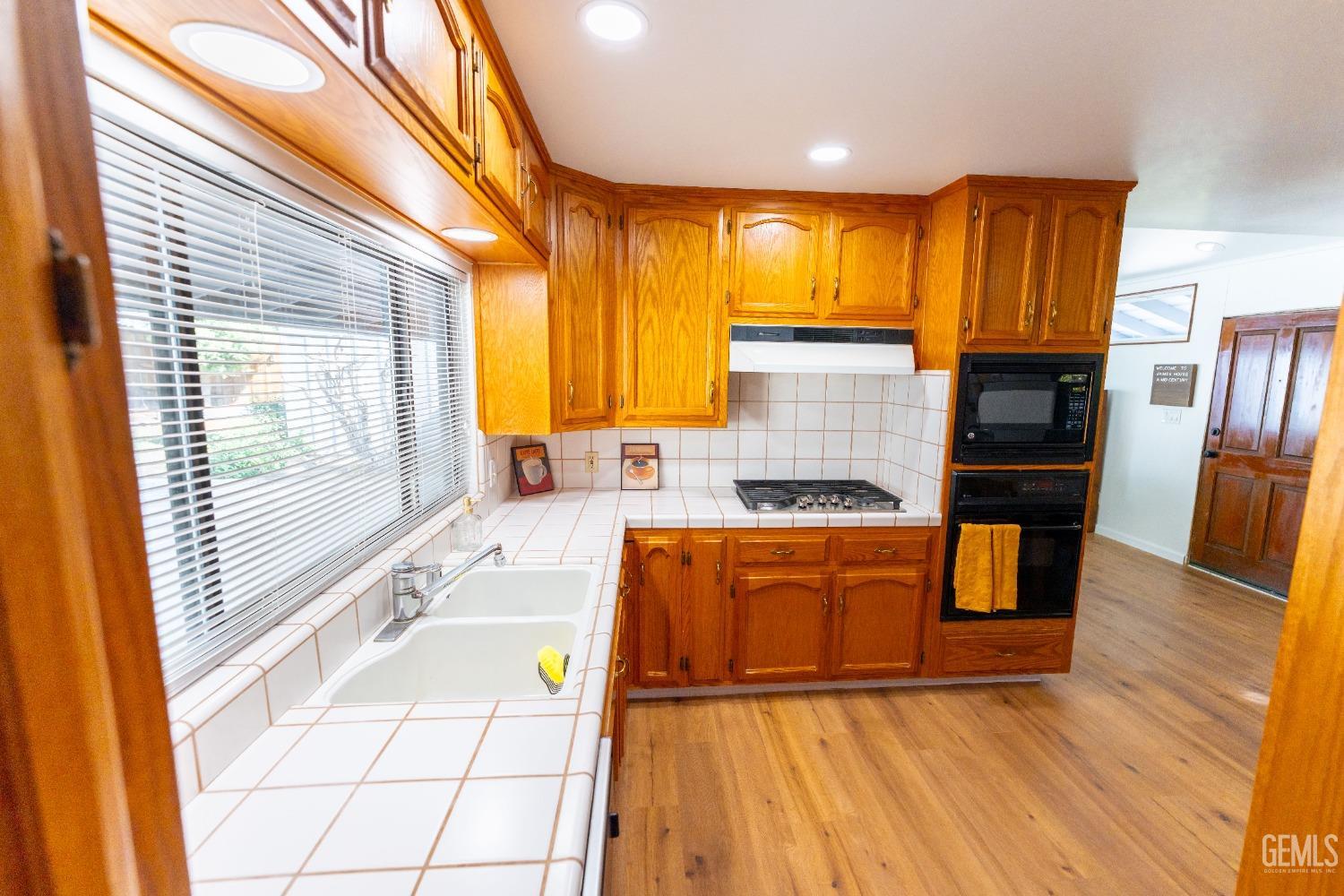 Undisclosed Address Bakersfield, CA 93306 - Photo 10 of 20 a kitchen with stainless steel appliances granite countertop a refrigerator a stove and a wooden cabinets