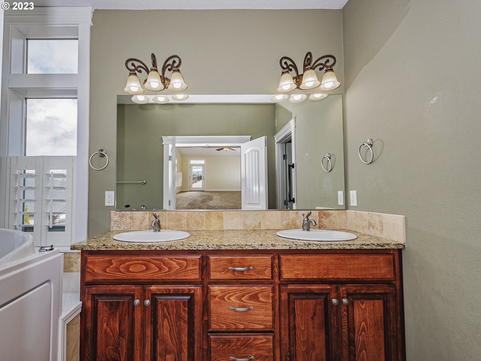 931 North 11th Place Ridgefield, WA 98642 - Photo 21 of 31 a bathroom with a granite countertop sink and a mirror