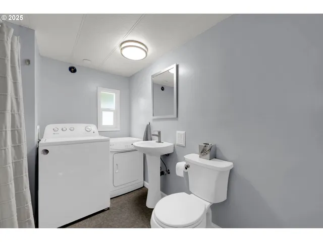 a bathroom with a sink mirror and shower