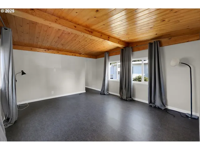 a view of a room with wooden floor