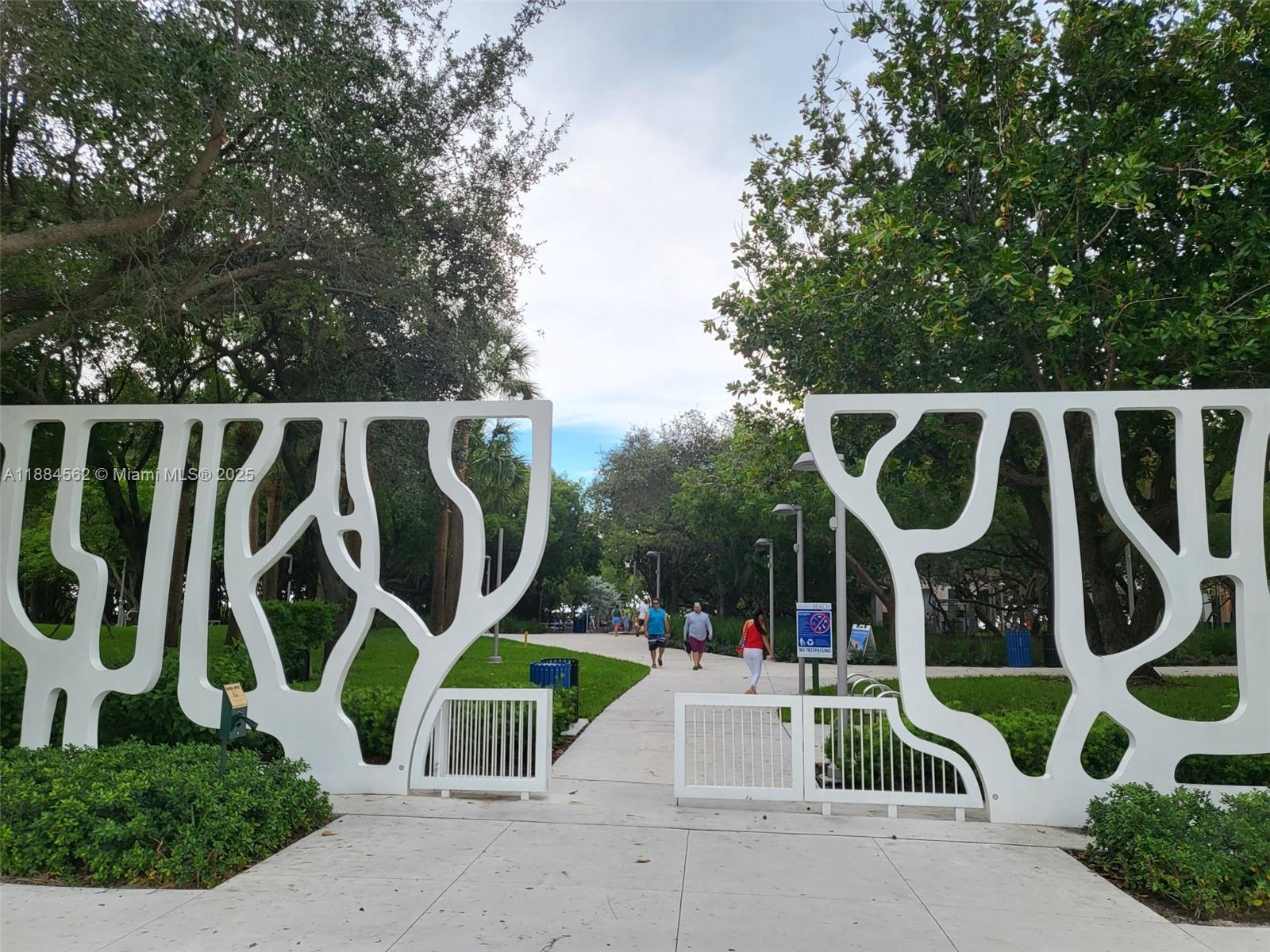 8425 Harding Avenue, Unit 1 Miami Beach, FL 33141 - Photo 12 of 16 an outdoor space with lots of white furniture and garden