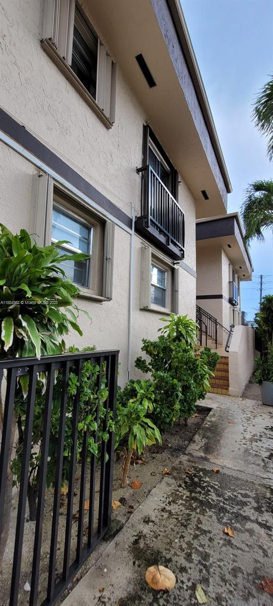 8425 Harding Avenue, Unit 1 Miami Beach, FL 33141 - Photo 16 of 16 a front view of a house with garden