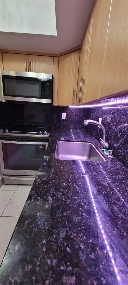 8425 Harding Avenue, Unit 1 Miami Beach, FL 33141 - Photo 4 of 16 a bathroom with a sink and a stove