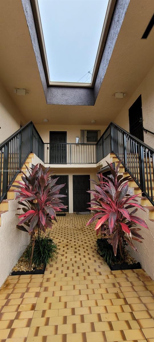 8425 Harding Avenue, Unit 1 Miami Beach, FL 33141 - Photo 10 of 16 a living room with furniture a flat screen tv and a floor to ceiling window