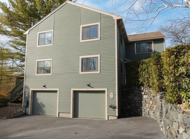 a view of a house with a yard and garage