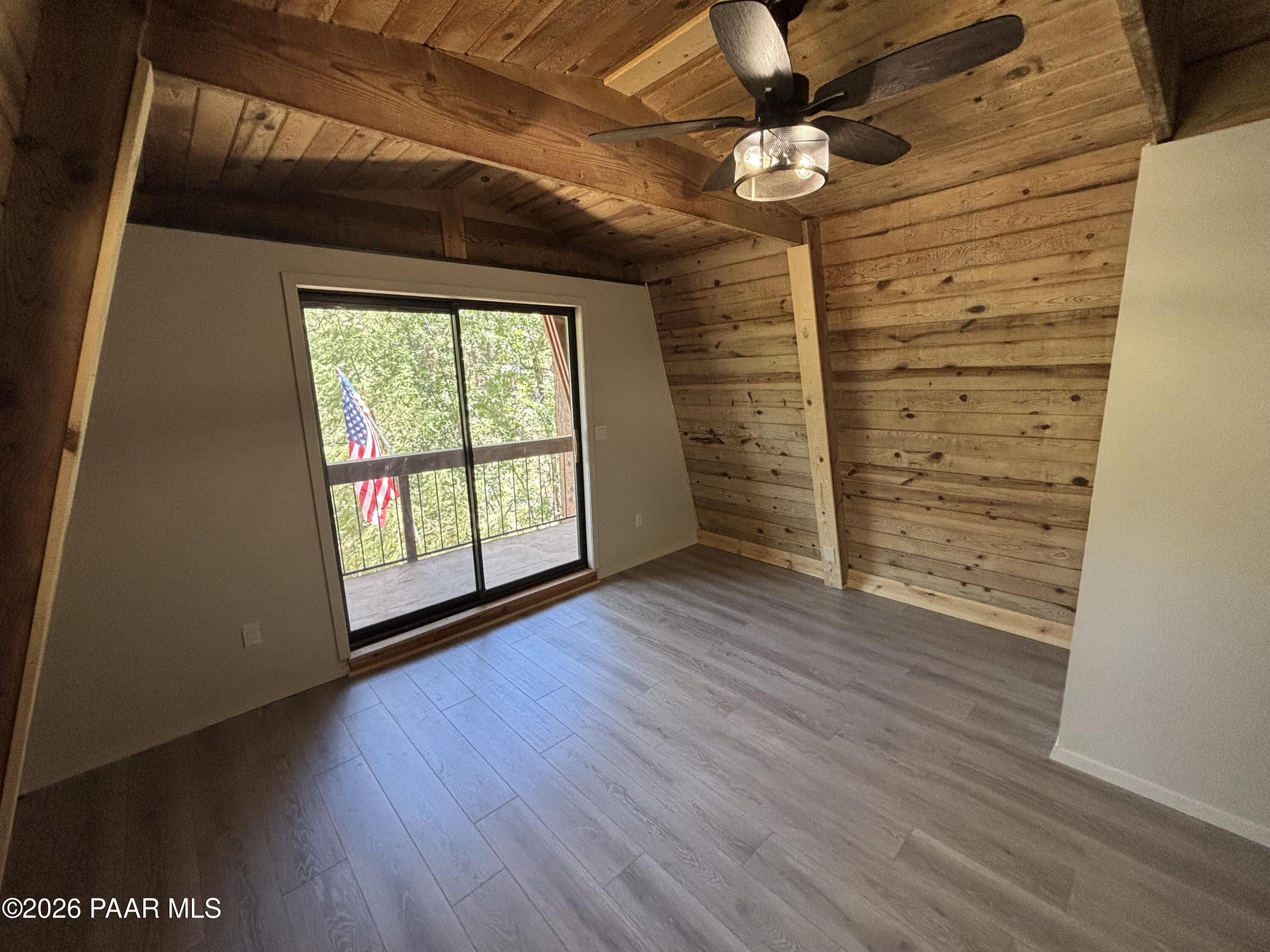 8550 South Breezy Pine Road Mayer, AZ 86333 - Photo 16 of 40 wooden floor in an empty room with a window