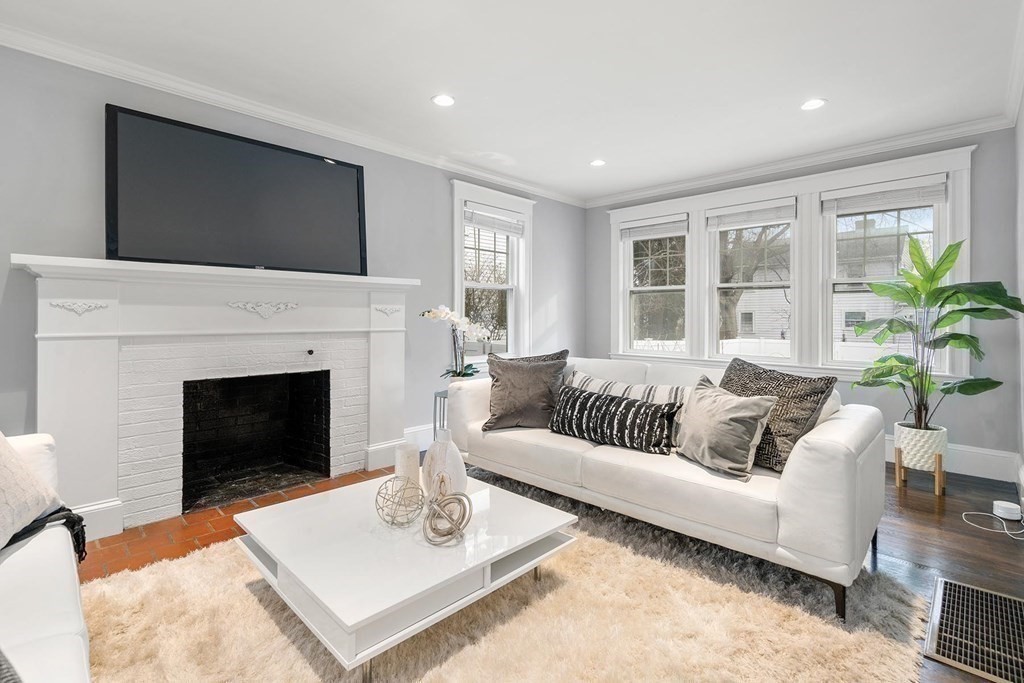 70 Falmouth Road Newton, MA 02465 - Photo 11 of 29 a living room with furniture a fireplace and a flat screen tv