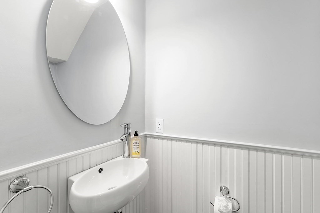 70 Falmouth Road Newton, MA 02465 - Photo 12 of 29 a bathroom with a sink and mirror