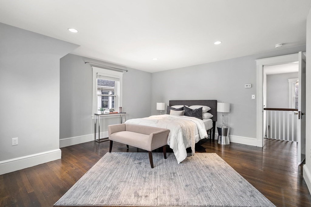 70 Falmouth Road Newton, MA 02465 - Photo 13 of 29 a bed sitting in a spacious bedroom next to a window and wooden floor