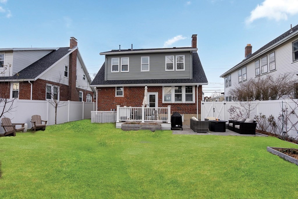 70 Falmouth Road Newton, MA 02465 - Photo 26 of 29 a view of a house with a yard and sitting area