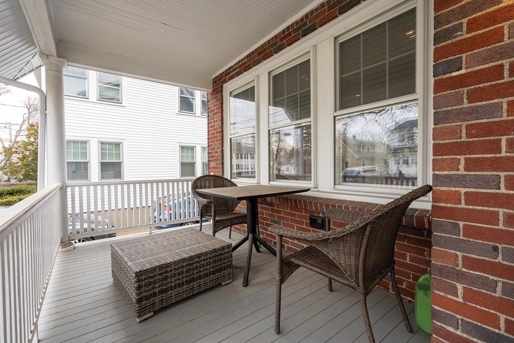 70 Falmouth Road Newton, MA 02465 - Photo 4 of 29 a view of a balcony with table and chairs