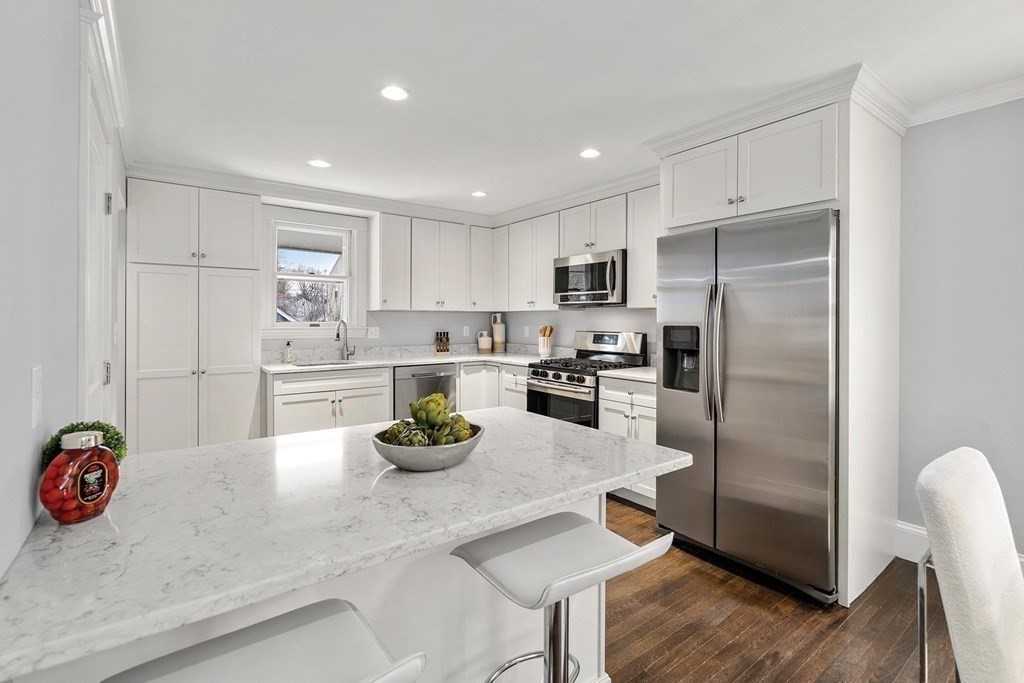 70 Falmouth Road Newton, MA 02465 - Photo 6 of 29 a kitchen with refrigerator and white cabinets