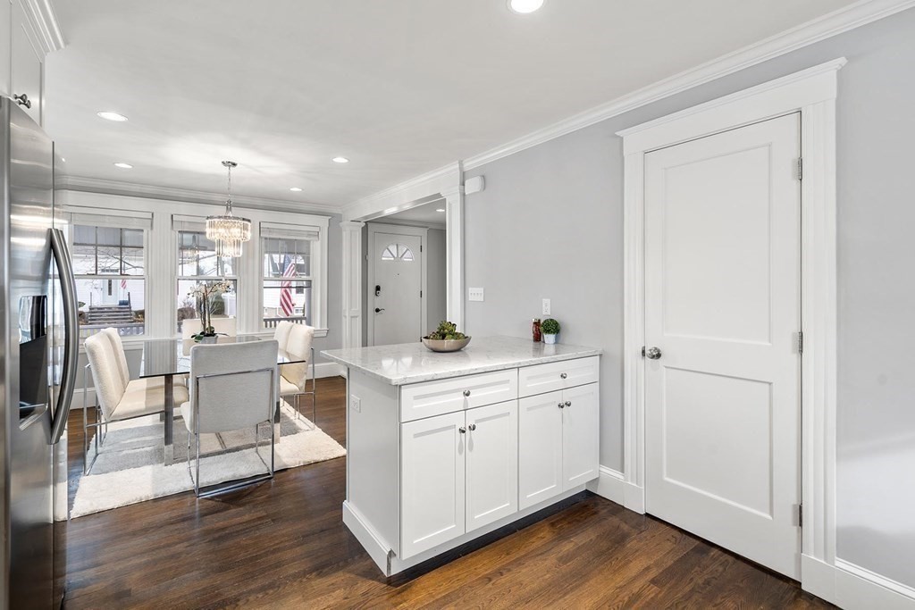 70 Falmouth Road Newton, MA 02465 - Photo 7 of 29 a view of kitchen with stainless steel appliances granite countertop refrigerator oven sink and wooden floor