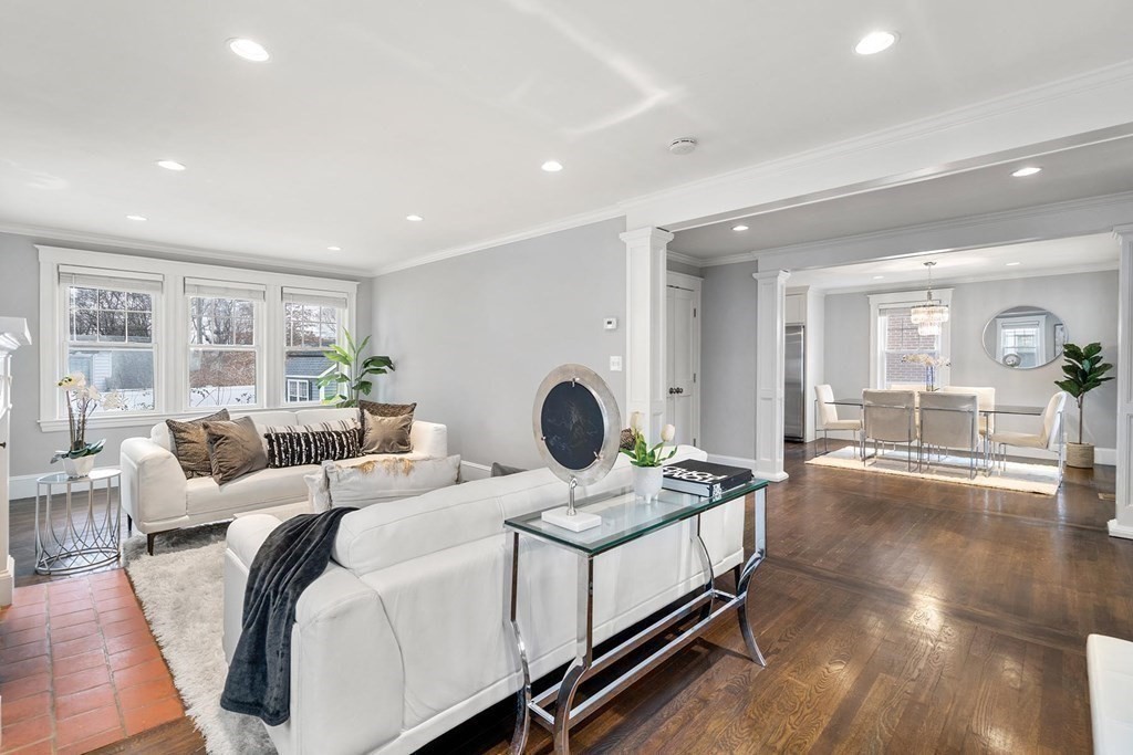 70 Falmouth Road Newton, MA 02465 - Photo 10 of 29 a living room with furniture a large window and chandelier