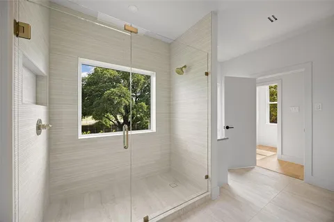 a bathroom that has a glass shower door