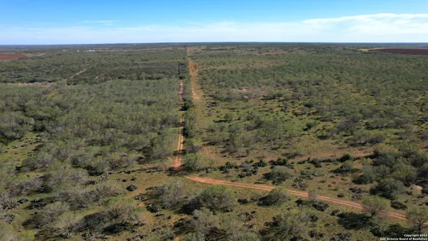 a view of a field with an ocean view