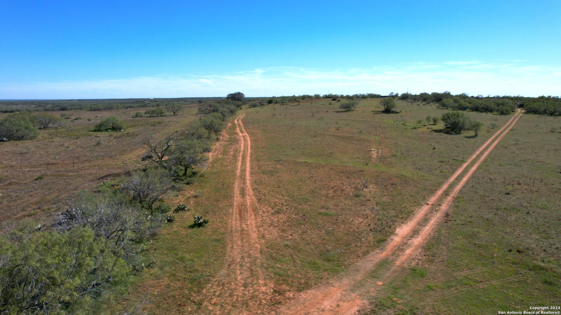 1913 County Road 3000 Pearsall, TX 78061 - Photo 7 of 38 a view of a dry yard with wooden floor and fence