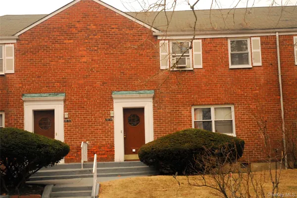 a backyard of a house with multiple windows