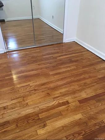 an empty room with wooden floor