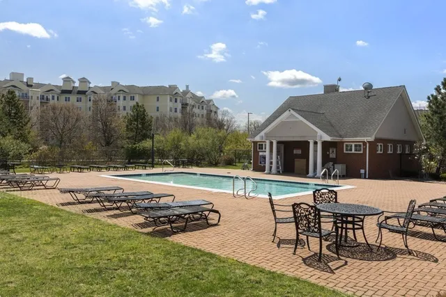 a view of a house with backyard and sitting area