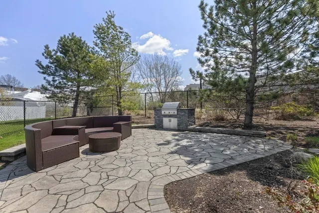 a view of a backyard with sitting area