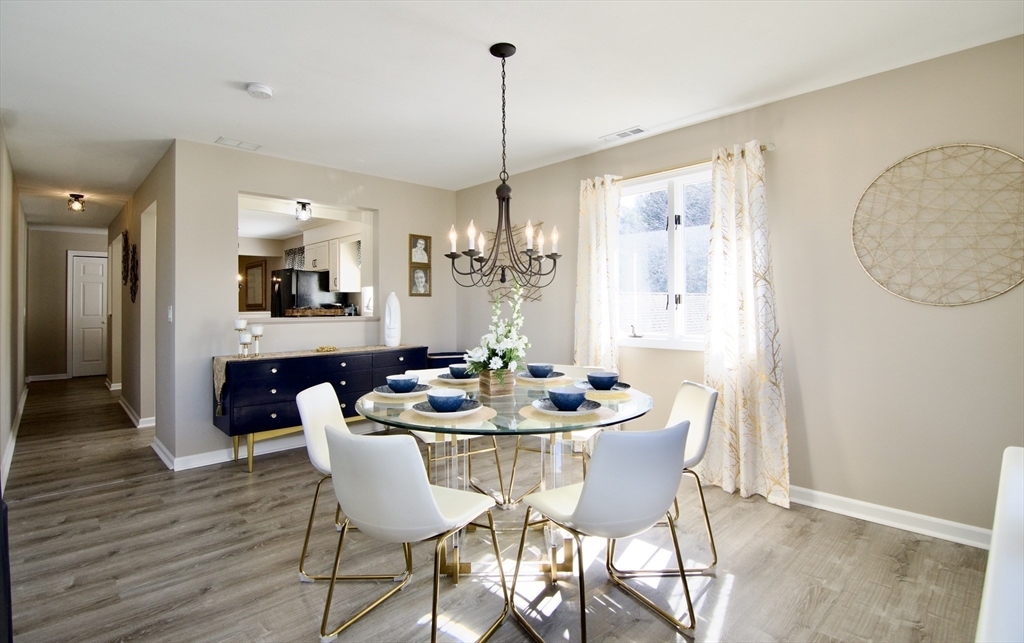 2205 Boston Road, Unit Q160 Wilbraham, MA 01095 - Photo 11 of 41 a dining room with furniture a chandelier and wooden floor