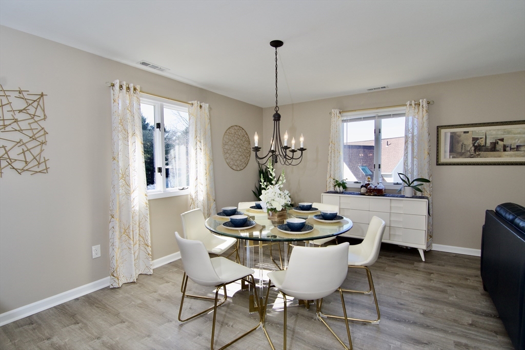 2205 Boston Road, Unit Q160 Wilbraham, MA 01095 - Photo 12 of 41 a dining room with furniture a window and wooden floor