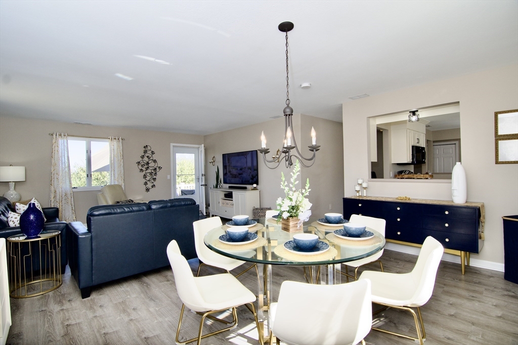 2205 Boston Road, Unit Q160 Wilbraham, MA 01095 - Photo 13 of 41 a view of a dining room and livingroom with furniture wooden floor a chandelier