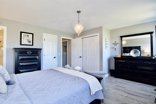 a bedroom with a bed and a potted plant