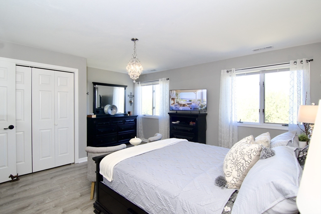 2205 Boston Road, Unit Q160 Wilbraham, MA 01095 - Photo 26 of 41 a bedroom with a bed and a chandelier
