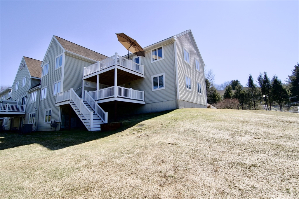 2205 Boston Road, Unit Q160 Wilbraham, MA 01095 - Photo 37 of 41 a front view of a house with a yard covered in snow