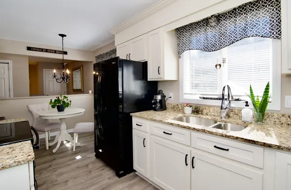 a kitchen with stainless steel appliances granite countertop a sink stove and cabinets