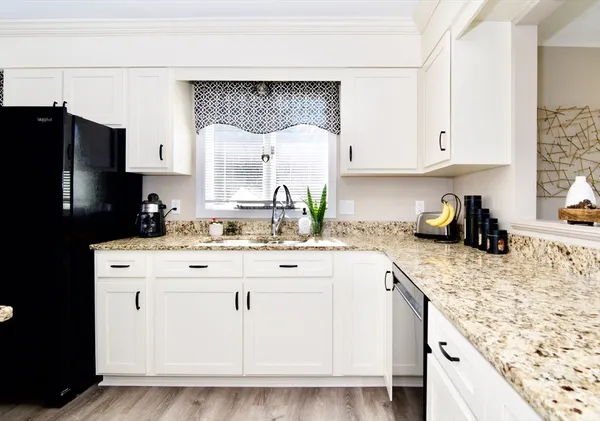 a kitchen with a stove microwave and sink