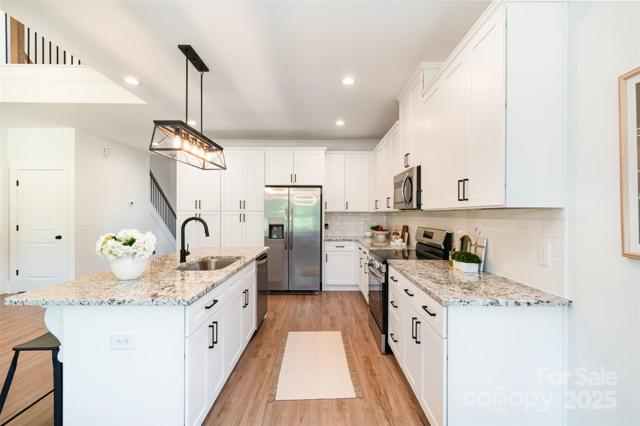 2133 Tite Road Stanfield, NC 28163 - Photo 11 of 35 a kitchen with granite countertop a sink stainless steel appliances and cabinets