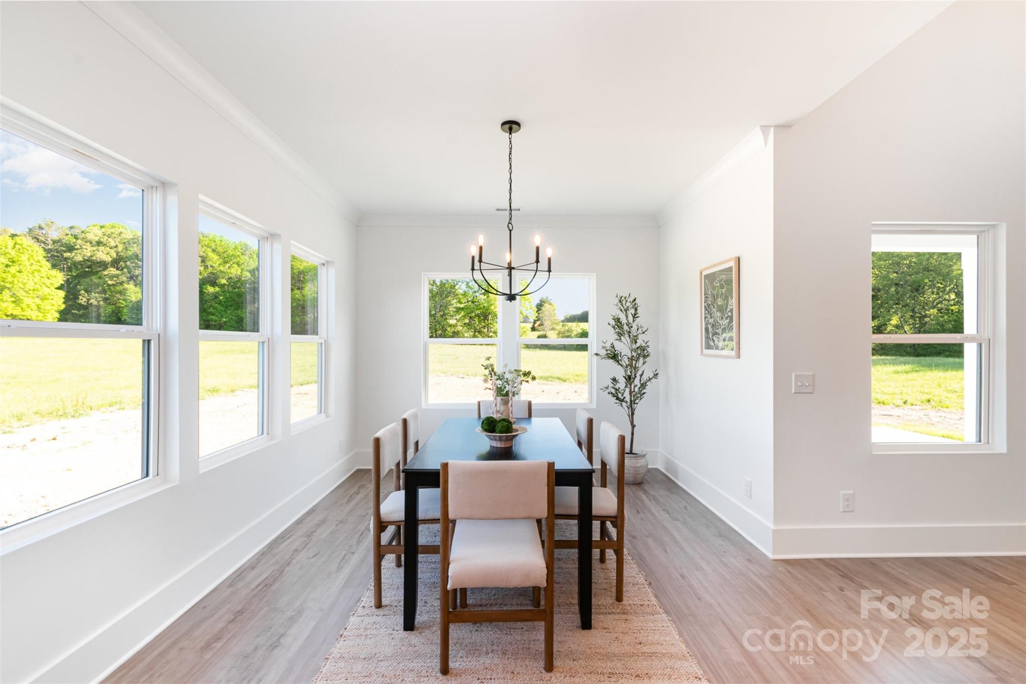 2133 Tite Road Stanfield, NC 28163 - Photo 13 of 35 a dining room with furniture a chandelier and wooden floor