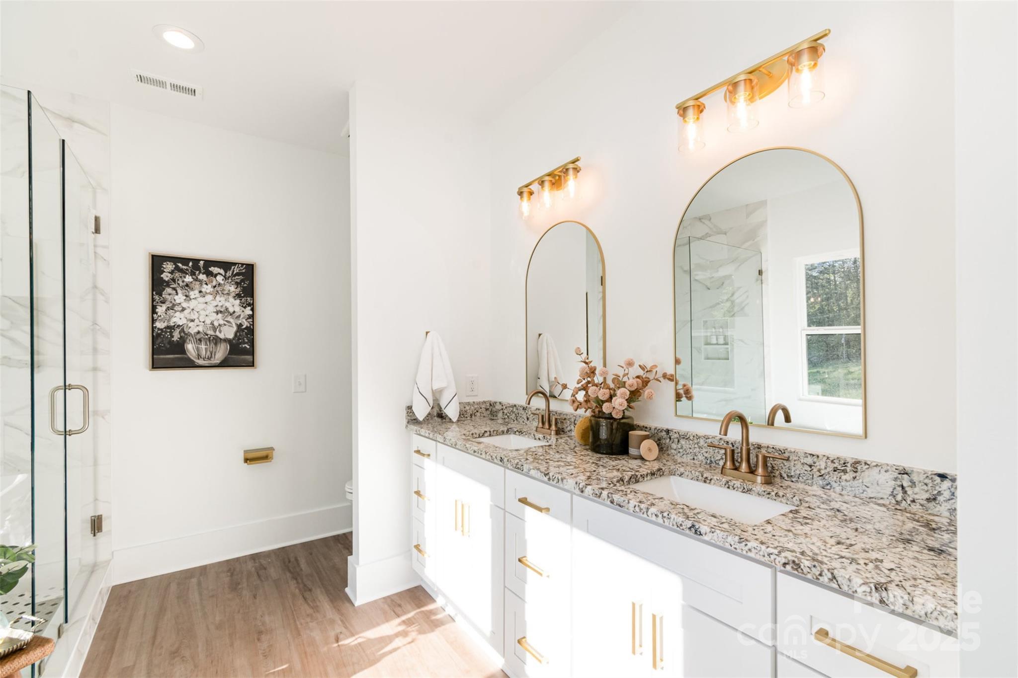 2133 Tite Road Stanfield, NC 28163 - Photo 16 of 35 a bathroom with double vanity sinks and a mirror