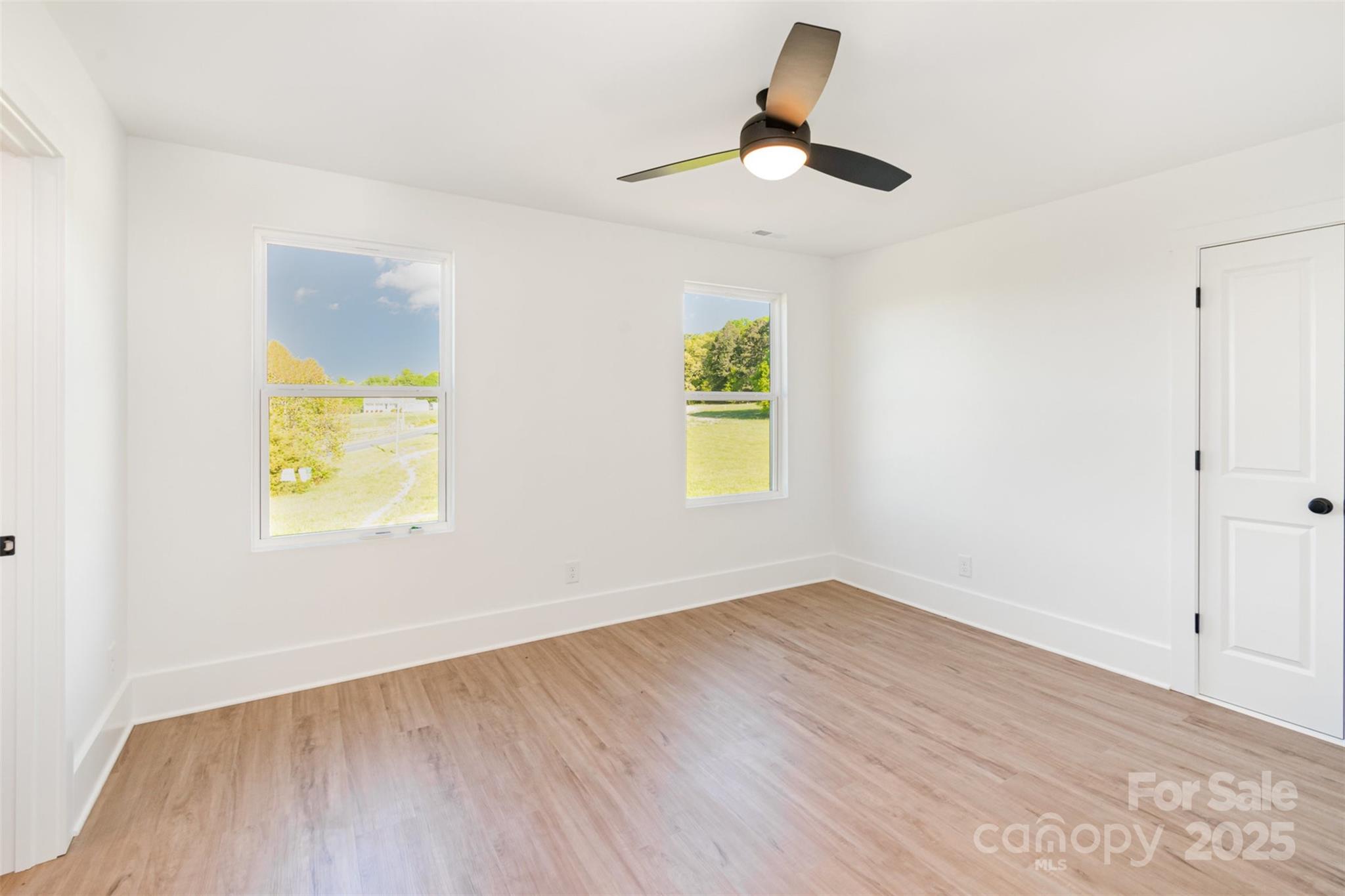 2133 Tite Road Stanfield, NC 28163 - Photo 19 of 35 an empty room with a window and a ceiling fan