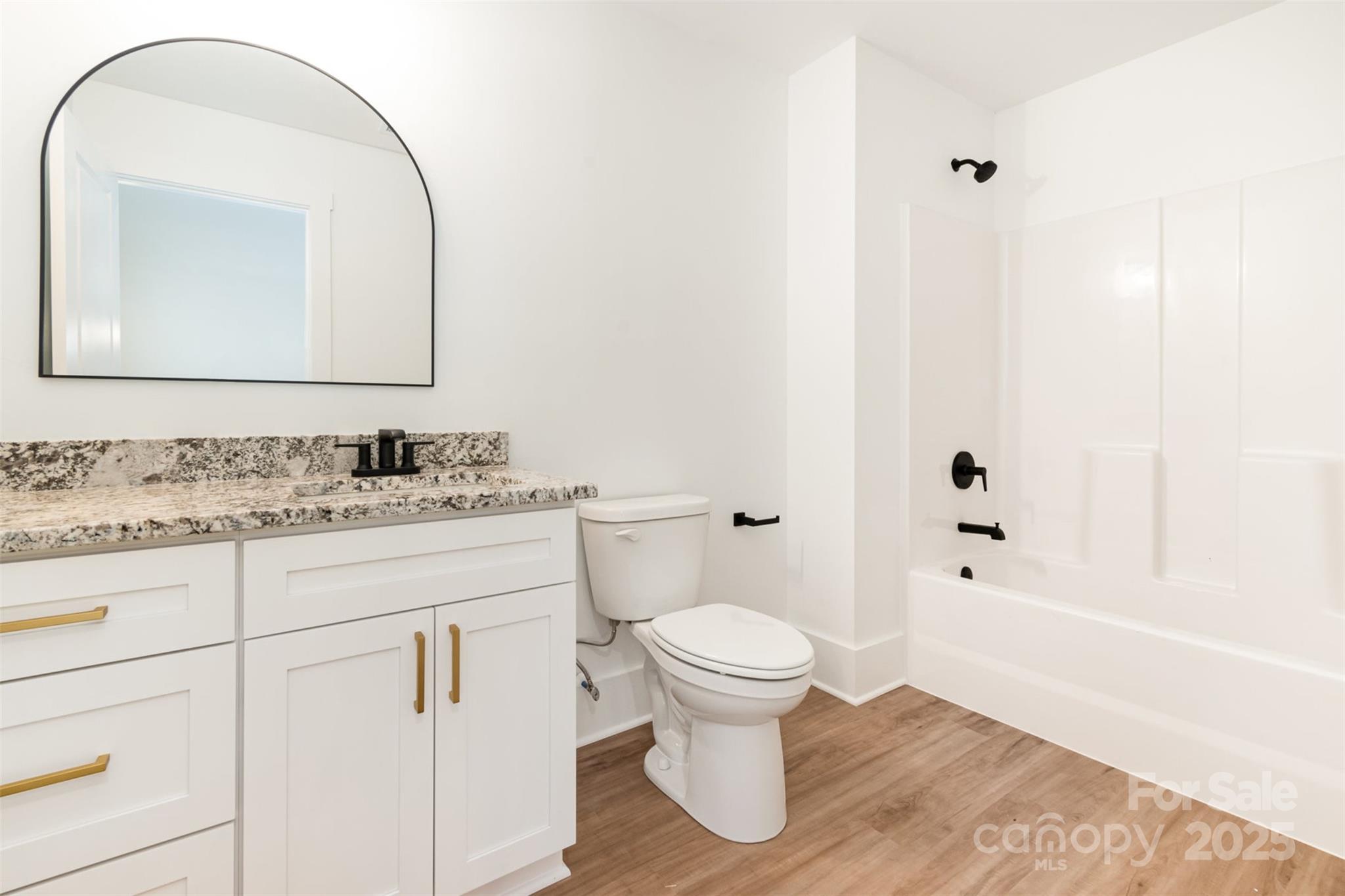 2133 Tite Road Stanfield, NC 28163 - Photo 21 of 35 a bathroom with a granite countertop sink toilet and shower