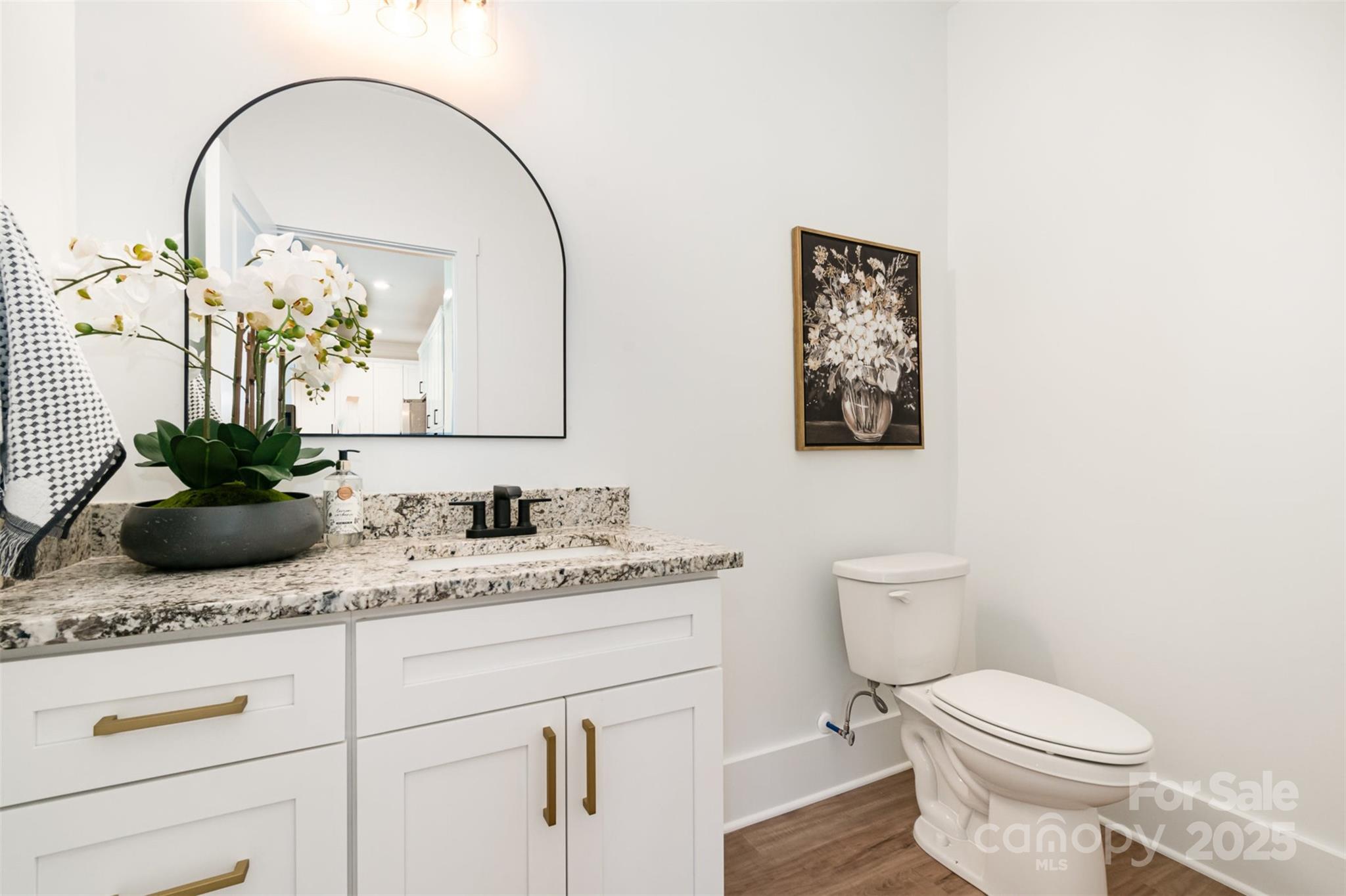 2133 Tite Road Stanfield, NC 28163 - Photo 24 of 35 a bathroom with a granite countertop toilet sink and mirror