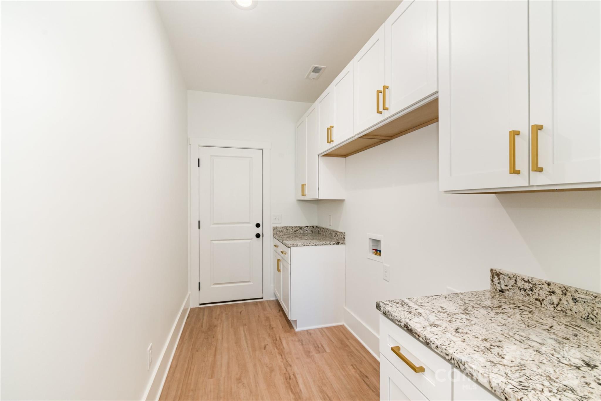 2133 Tite Road Stanfield, NC 28163 - Photo 26 of 35 a kitchen with a sink and wooden floor