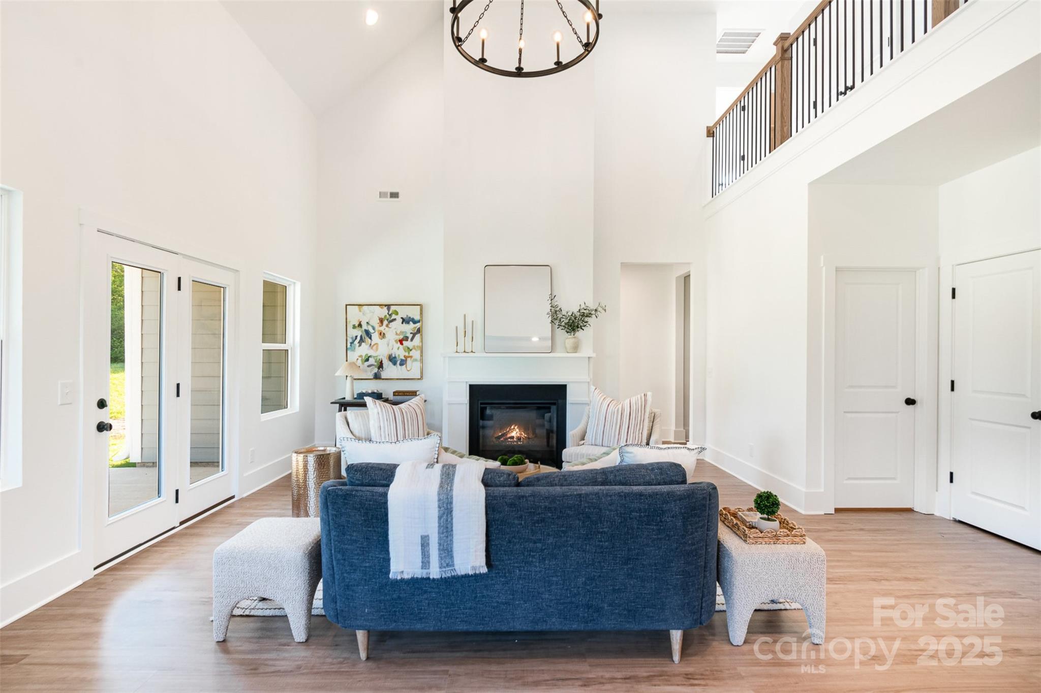 2133 Tite Road Stanfield, NC 28163 - Photo 6 of 35 a living room with furniture a fireplace and a large window