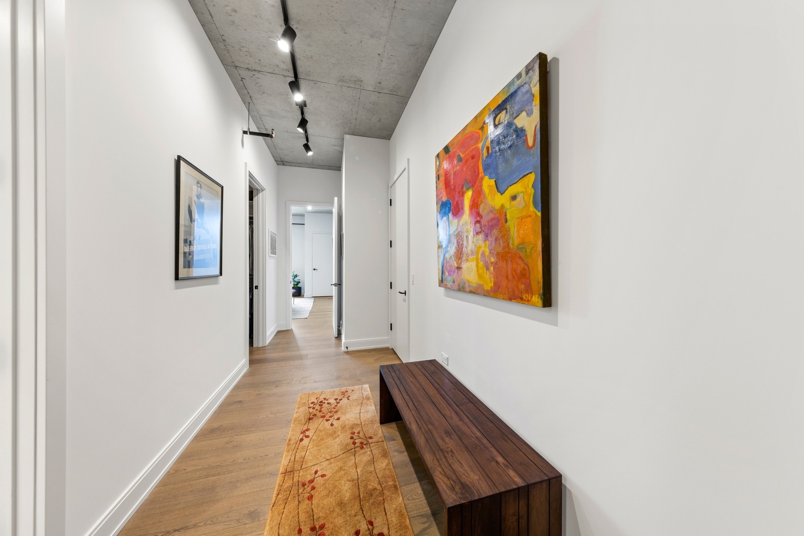111 South Peoria Street, Unit 703 Chicago, IL 60607 - Photo 11 of 18 a view of a hallway with wooden floor