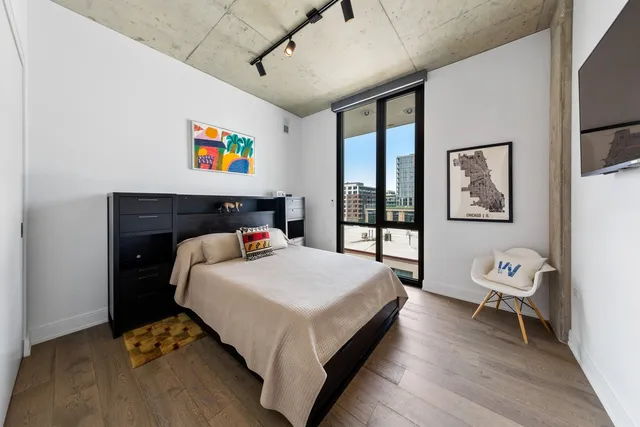 a bed sitting in a bedroom next to a window