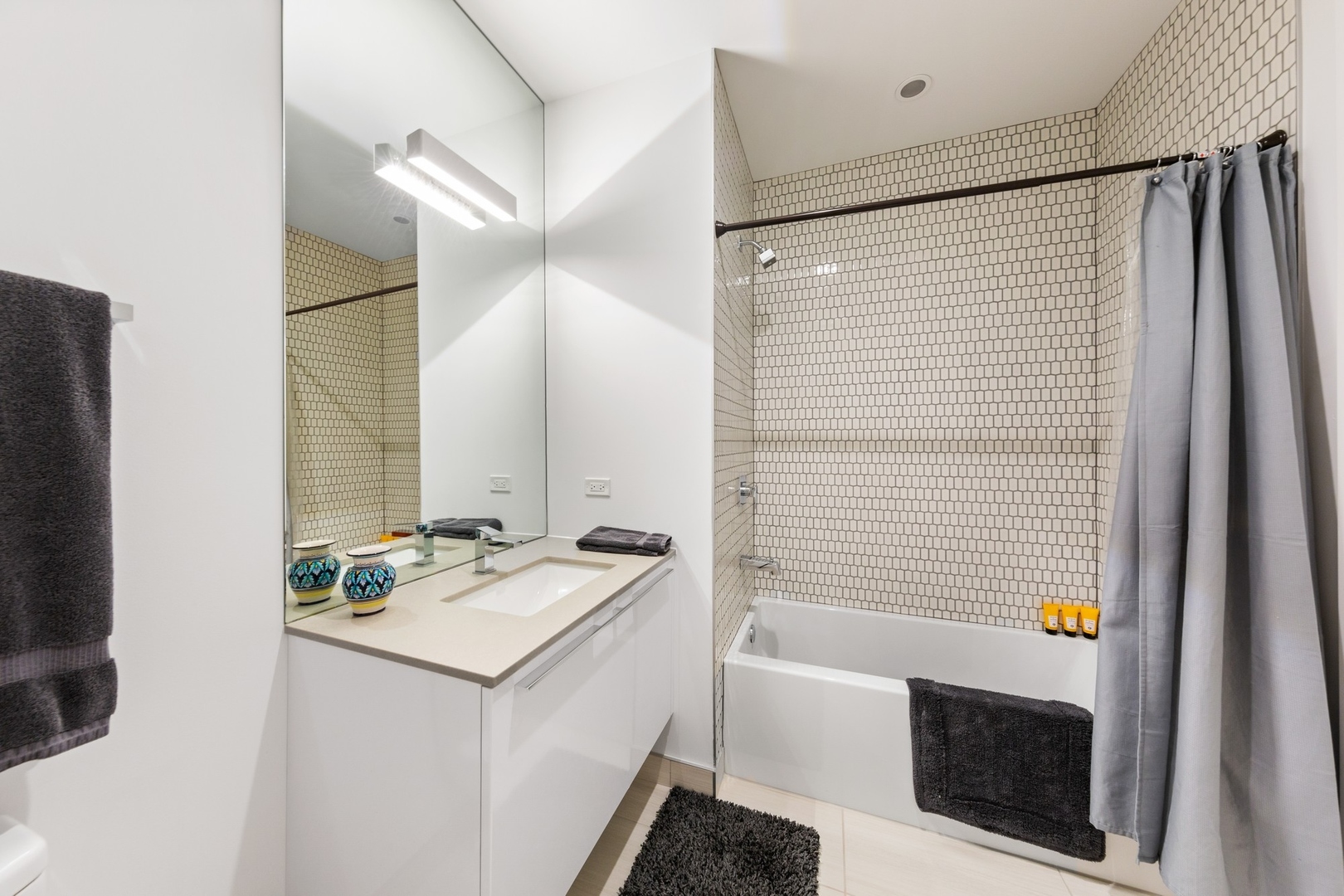 111 South Peoria Street, Unit 703 Chicago, IL 60607 - Photo 16 of 18 a bathroom with a sink and a mirror