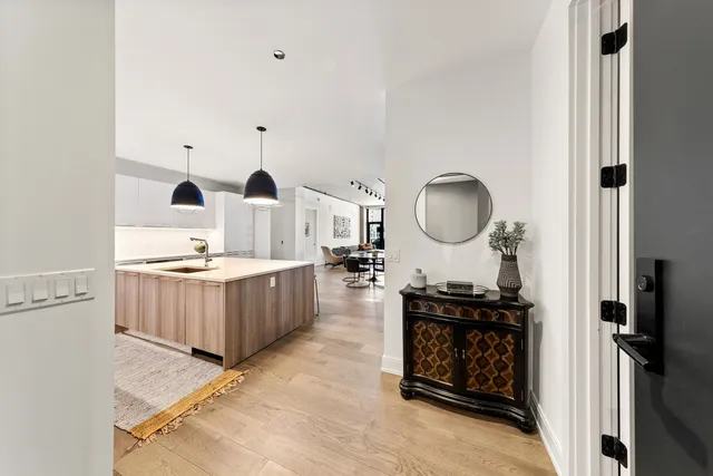 a living room with furniture and a mirror